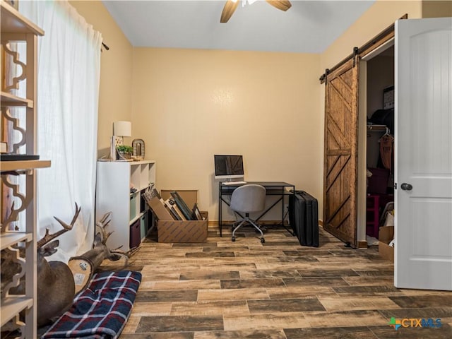 12093 Sulphur Springs Rd, Adkins, TX 78101 - office with a barn door, a ceiling fan, and wood finished floors