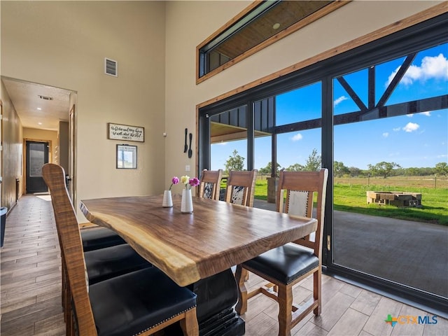 12093 Sulphur Springs Rd, Adkins, TX 78101 - dining area with light wood finished floors, a high ceiling, and plenty of natural light