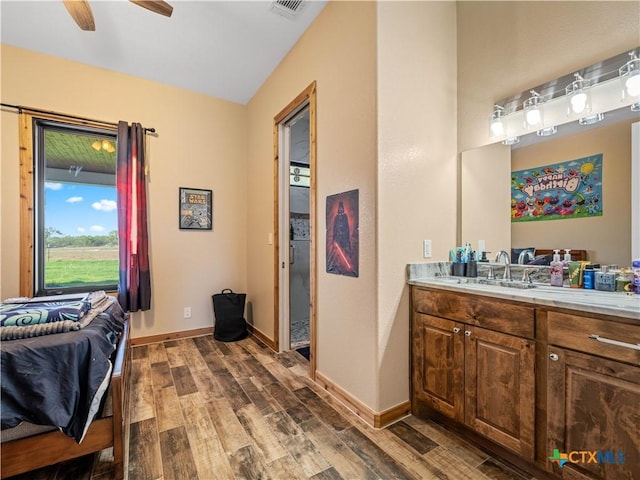 12093 Sulphur Springs Rd, Adkins, TX 78101 - ensuite bathroom featuring wood finished floors, vanity, ceiling fan, and baseboards