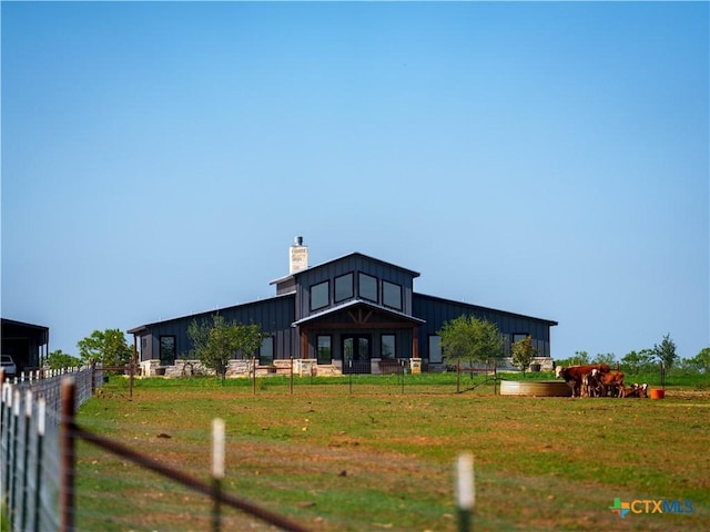 12093 Sulphur Springs Rd, Adkins, TX 78101 - view of front of house featuring board and batten siding, a chimney, and fence
