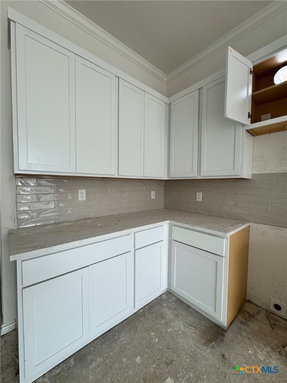 1261 Bending Branch Way, Temple, TX 76502 - kitchen with crown molding, backsplash, light stone counters, open shelves, and white cabinetry