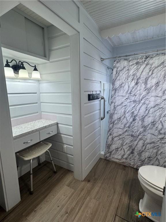 bathroom featuring hardwood / wood-style floors and toilet