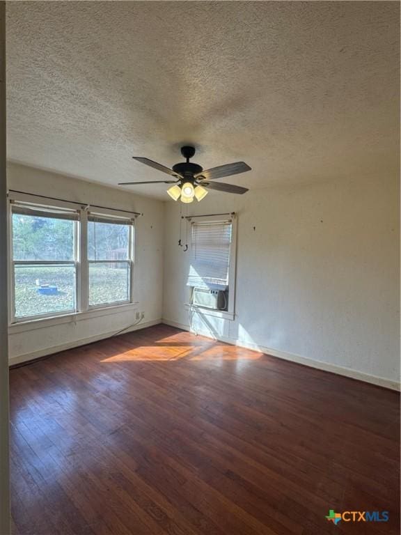 unfurnished room with a textured ceiling, dark hardwood / wood-style floors, ceiling fan, and cooling unit