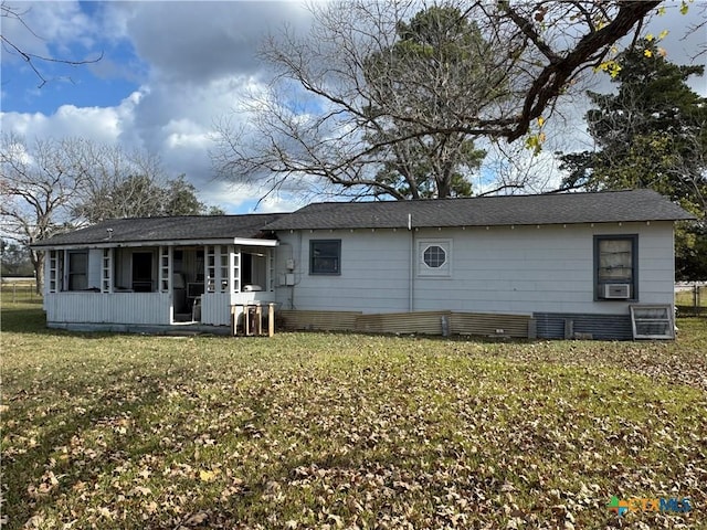 back of property with a lawn and cooling unit