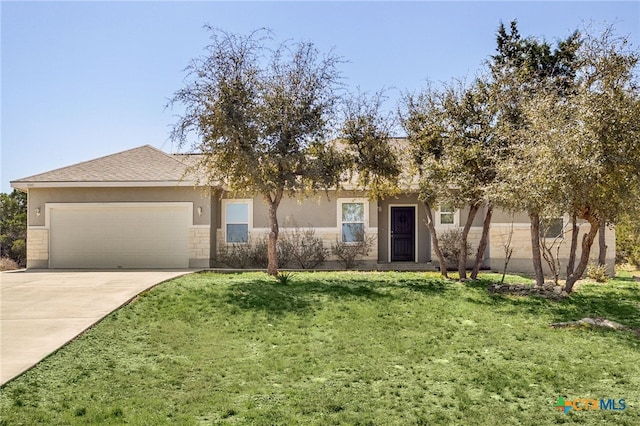 view of front of house featuring a garage, concrete driveway, a front lawn, and stucco siding