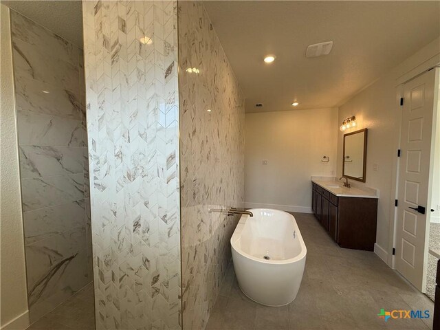 901 High Plains Dr, Nolanville, TX 76559 - full bathroom with a freestanding tub, vanity, a walk in shower, and recessed lighting