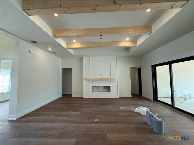 901 High Plains Dr, Nolanville, TX 76559 - unfurnished living room featuring beam ceiling, dark wood-style flooring, baseboards, and rail lighting