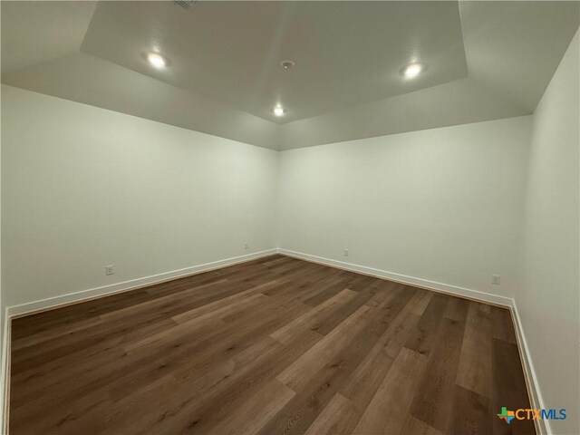 901 High Plains Dr, Nolanville, TX 76559 - spare room with vaulted ceiling, dark wood-type flooring, baseboards, and recessed lighting