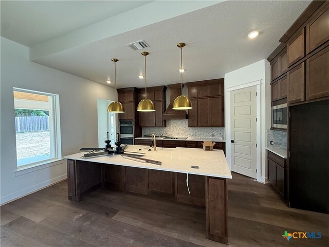 901 High Plains Dr, Nolanville, TX 76559 - kitchen with dark wood finished floors, tasteful backsplash, wall chimney exhaust hood, and recessed lighting