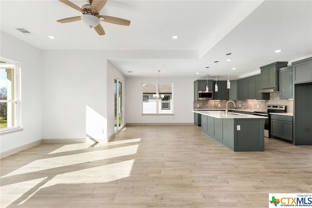 kitchen with hanging light fixtures, plenty of natural light, stainless steel electric stove, and sink