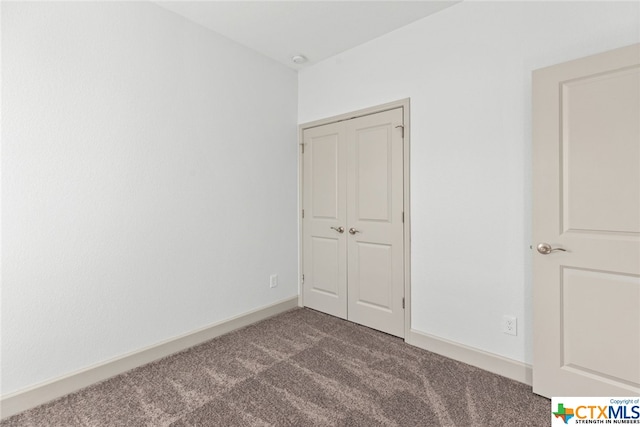 unfurnished bedroom with carpet flooring and a closet