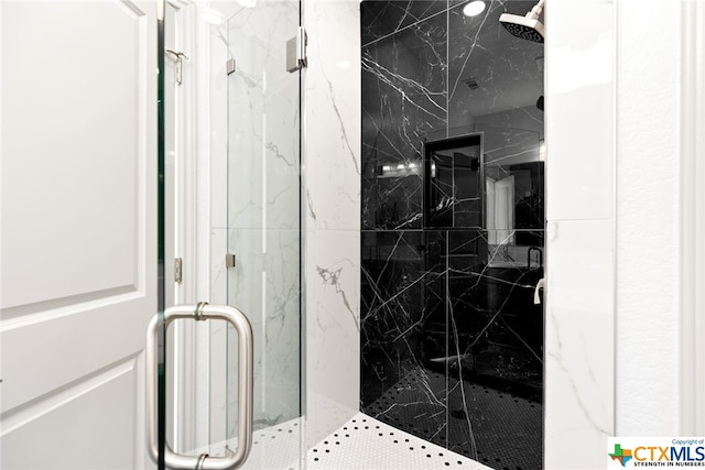 bathroom with a shower with door