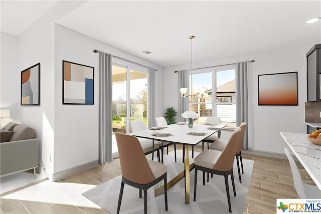 dining space with an inviting chandelier