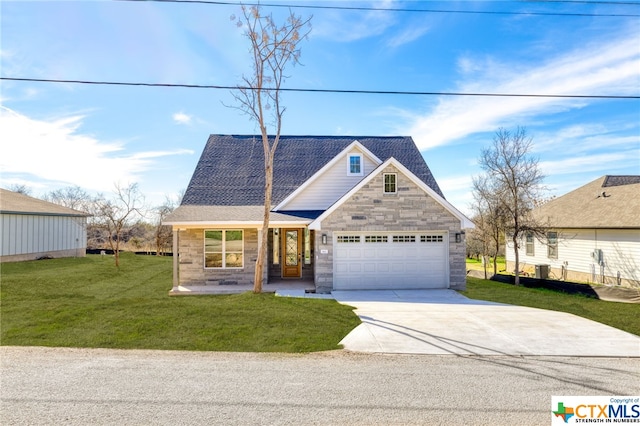 view of front facade featuring covered porch, a garage, and a front lawn