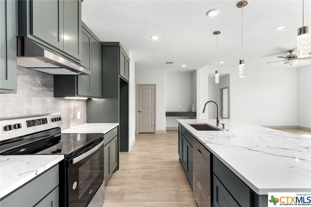 kitchen featuring pendant lighting, light stone counters, sink, and stainless steel appliances