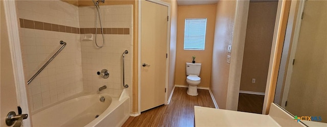 bathroom with wood-type flooring, bathtub / shower combination, and toilet