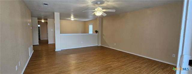 spare room featuring dark hardwood / wood-style flooring and ceiling fan