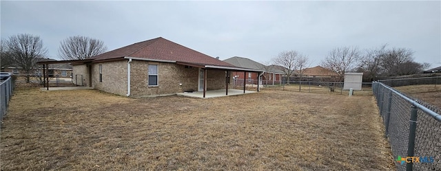 rear view of house featuring a patio area and a lawn