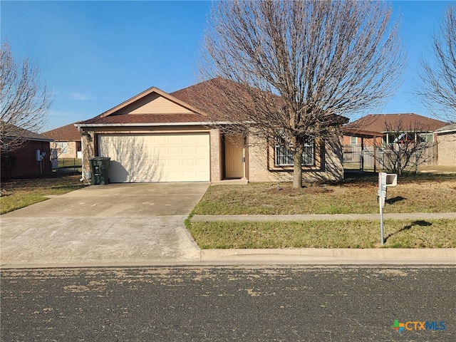 ranch-style home featuring a garage and a front yard