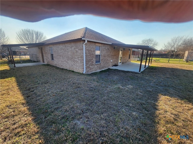 view of home's exterior with a patio and a yard