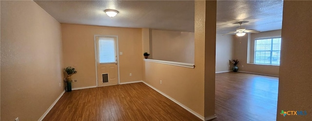 interior space with hardwood / wood-style floors, a textured ceiling, and ceiling fan