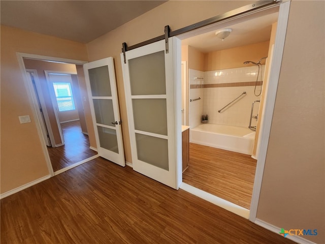 interior space featuring dark wood-type flooring and a barn door