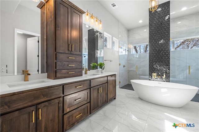 full bath featuring marble finish floor, a shower with shower door, a sink, and visible vents