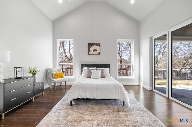 bedroom featuring access to outside, multiple windows, high vaulted ceiling, and dark wood-type flooring