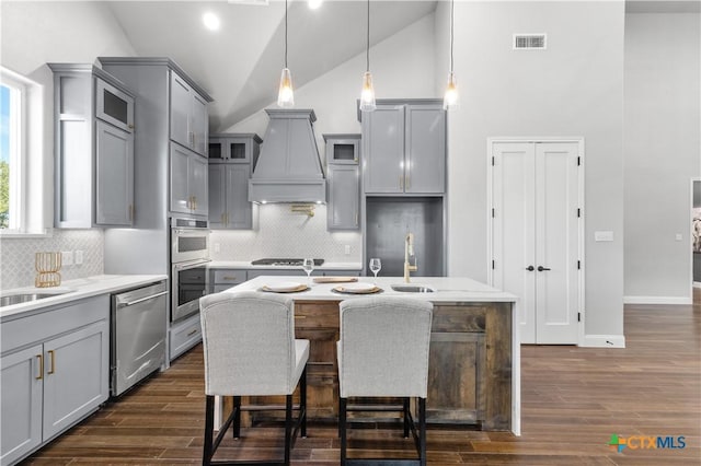 kitchen featuring visible vents, appliances with stainless steel finishes, gray cabinets, and dark wood finished floors