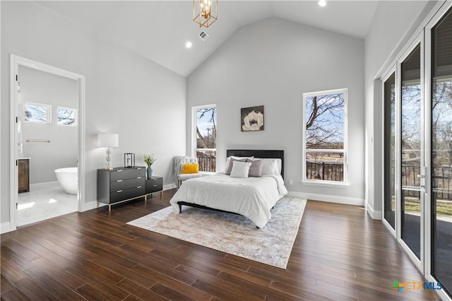 bedroom with multiple windows and wood finished floors