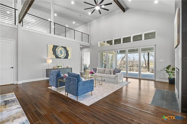 6817 Misty Creek Ln, Temple, TX 76502 - living area featuring high vaulted ceiling, beam ceiling, a ceiling fan, wood finished floors, and a tile fireplace