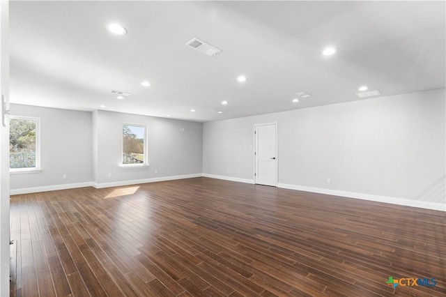 interior space with a wealth of natural light, visible vents, dark wood-style flooring, and recessed lighting