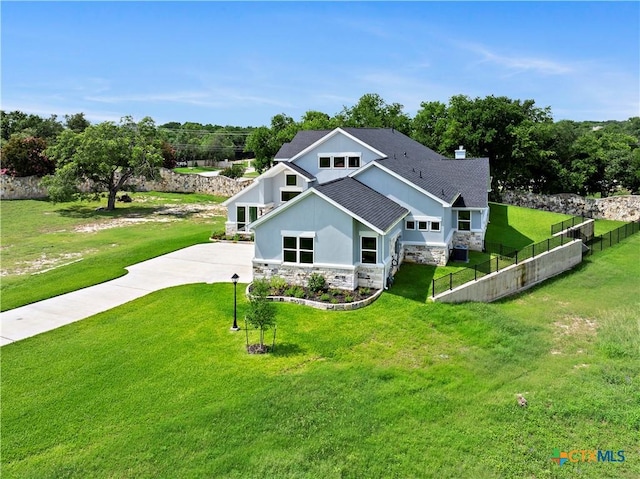 6817 Misty Creek Ln, Temple, TX 76502 - view of front facade with stone siding, stucco siding, concrete driveway, roof with shingles, and a chimney