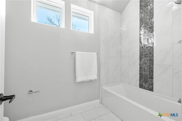 full bathroom featuring shower / bath combination, marble finish floor, and baseboards