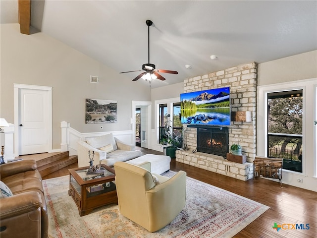 living room featuring a fireplace, plenty of natural light, wood-type flooring, and ceiling fan