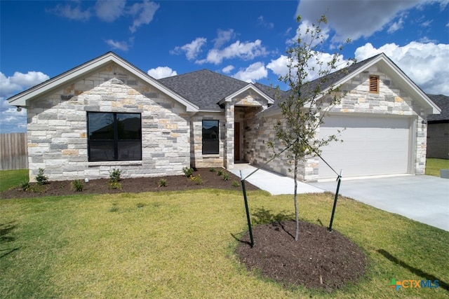 view of front of home with a front lawn and a garage