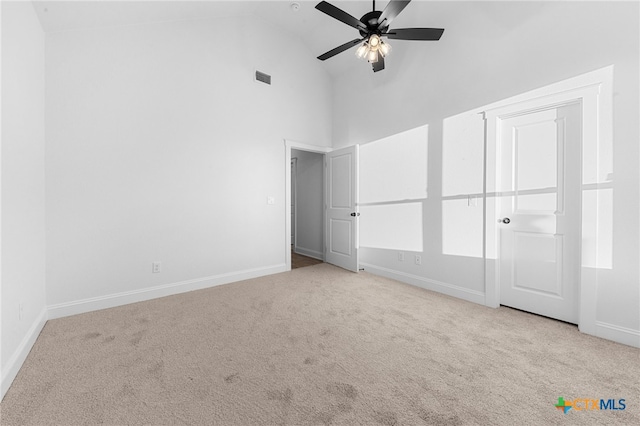 unfurnished bedroom featuring high vaulted ceiling, light carpet, and ceiling fan