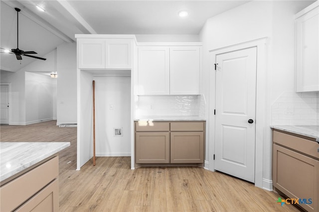 kitchen with light wood-type flooring, decorative backsplash, ceiling fan, and light stone counters