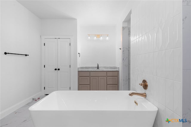 bathroom with tile walls, vanity, and a tub