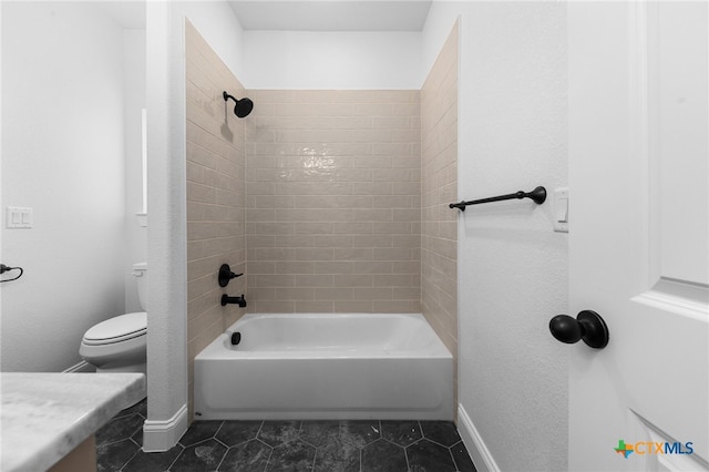 full bathroom with vanity, tile patterned floors, toilet, and tiled shower / bath combo