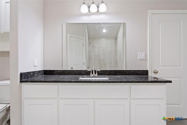 bathroom featuring a shower, vanity, and toilet