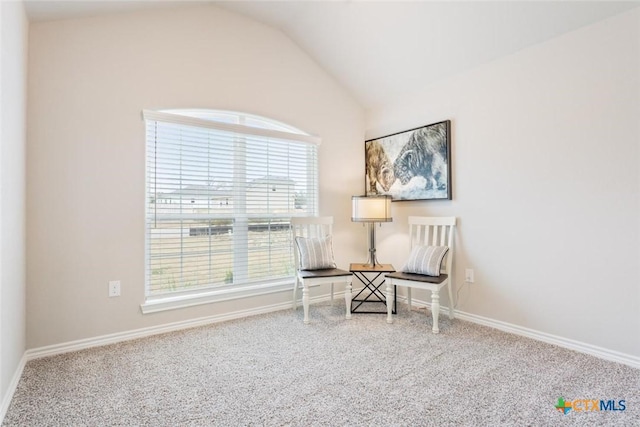 living area featuring carpet floors and lofted ceiling