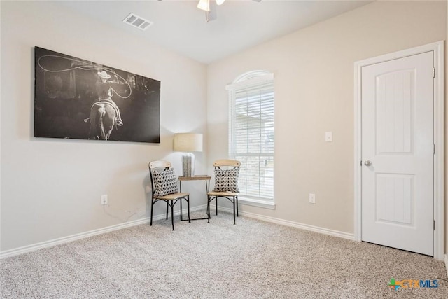 sitting room featuring a wealth of natural light, carpet, and ceiling fan