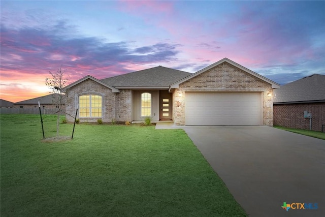 view of front of home featuring a garage and a lawn