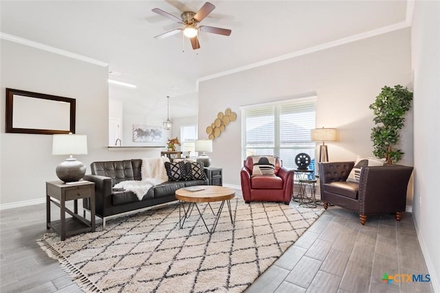 living room with ceiling fan and ornamental molding