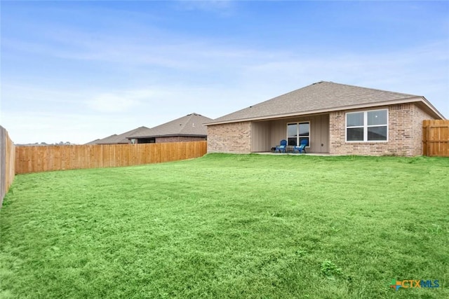 rear view of house with a lawn