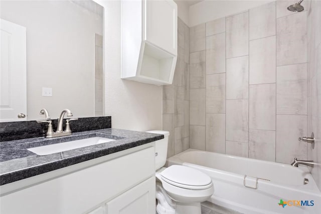 full bathroom with vanity, tiled shower / bath combo, and toilet