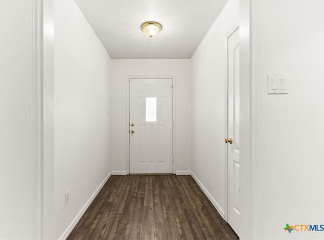 entryway with dark wood-type flooring and baseboards