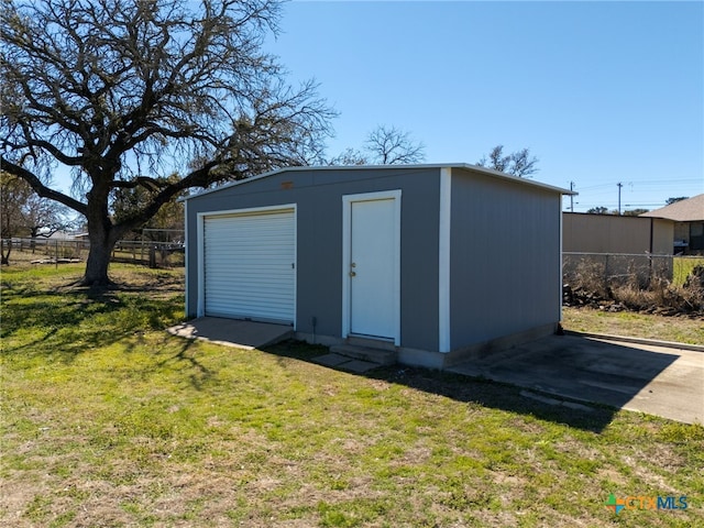 view of outbuilding with an outdoor structure and fence