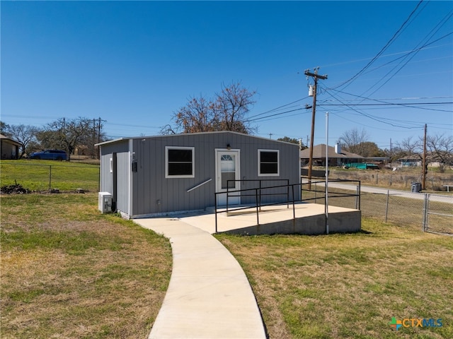 view of front of property featuring central AC unit, a front lawn, and fence